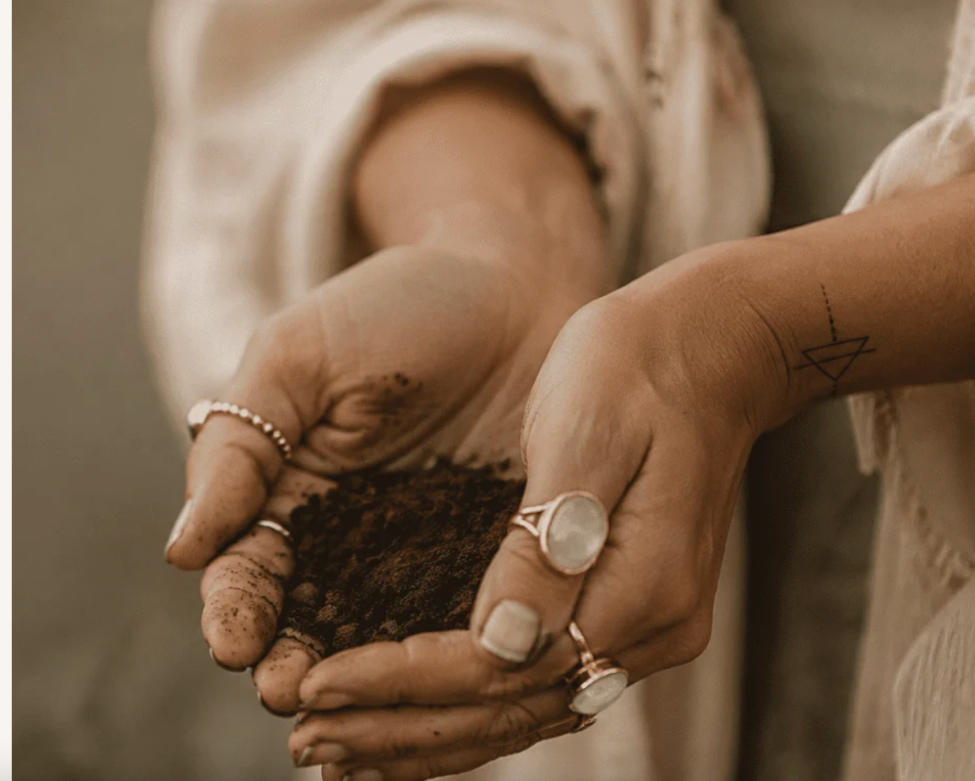 Hands holding a small mound of rich soil